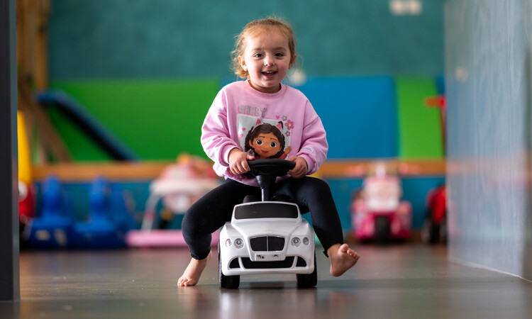 Kasey on a car in kitchen